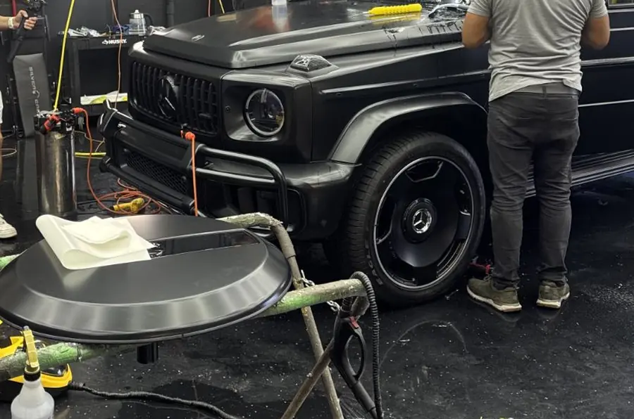 Mercedes-AMG G63 front end and wheel in the SFS Bay Area installation bay, with installation tooling in the foreground