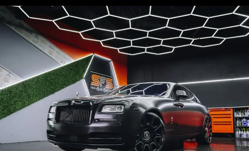 Matte black Rolls-Royce Wraith inside the SFS Bay Area studio under hexagonal LED lighting