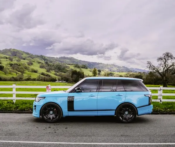 Light blue Range Rover with a color change finish photographed on a road in the hills outside San Jose