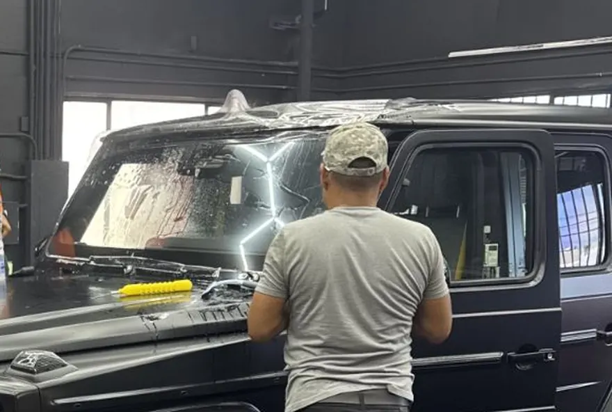 LUXE Windshield Guard being wet-applied to a Mercedes-AMG G63 windshield at SFS Bay Area